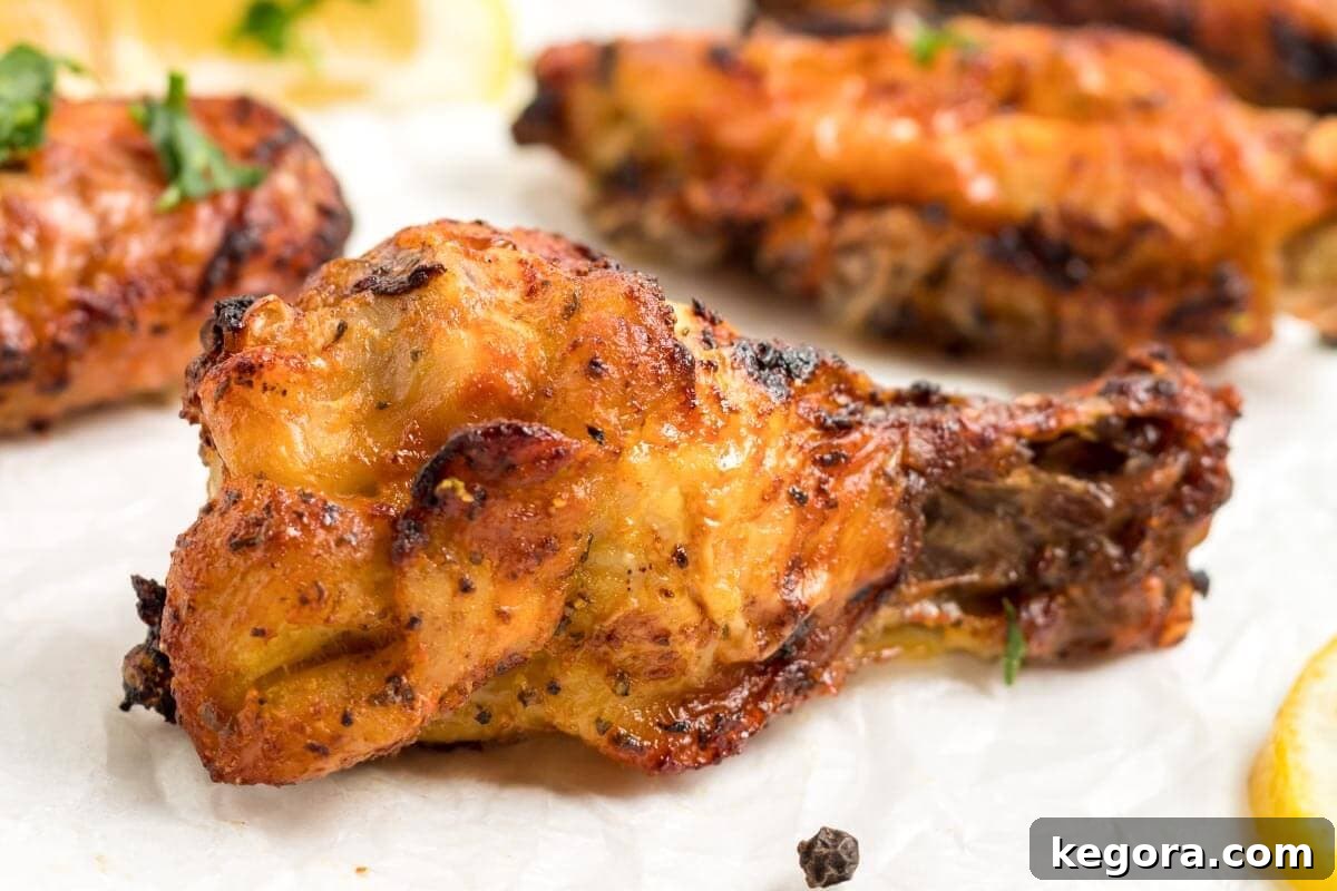 A perfectly air-fried lemon pepper chicken wing drumette, golden brown and crispy.