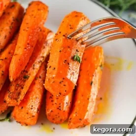 Air Fryer Carrots on plate with fork.