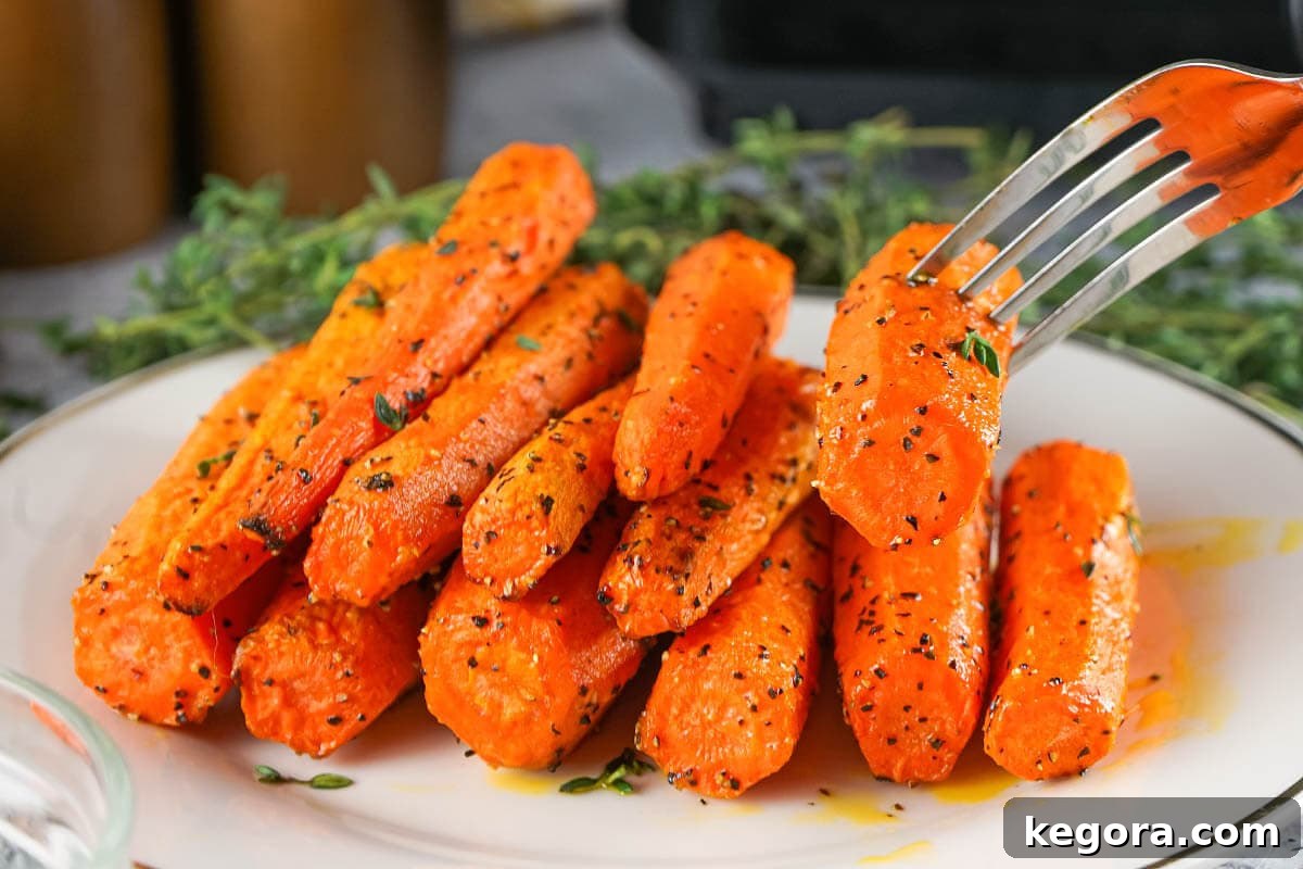 Crispy Air Fryer Carrots 7 Air Fryer Carrots on plate with fork.