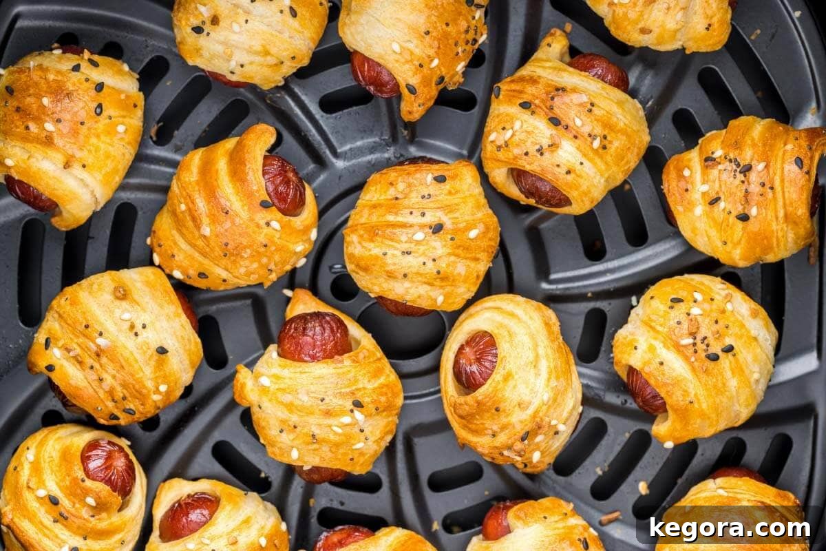 A close-up shot of golden brown Air Fryer Pigs in a Blanket, highlighting their crispy texture and delicious appeal.