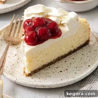 A magnificent gluten-free vanilla bean cheesecake, perfectly baked and generously topped with a vibrant cherry filling, presented on a dark plate, inviting a decadent taste.