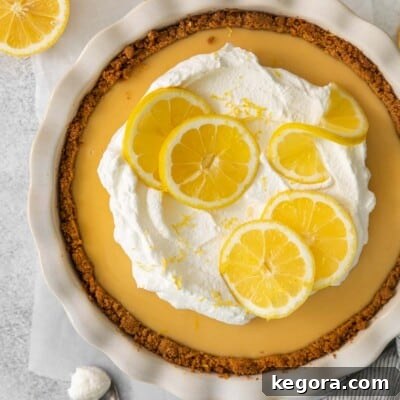 An inviting overhead view of a perfectly smooth and creamy gluten-free lemon cream pie, showcasing its vibrant yellow filling and delicate crust.