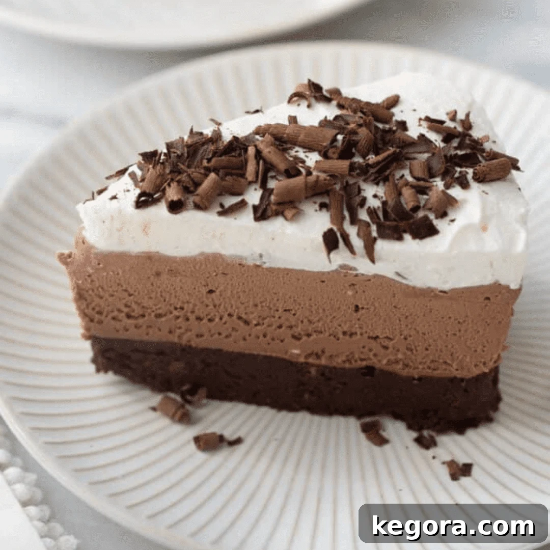 A rich slice of gluten-free chocolate mousse cake on a plate, showcasing its luxurious layers.