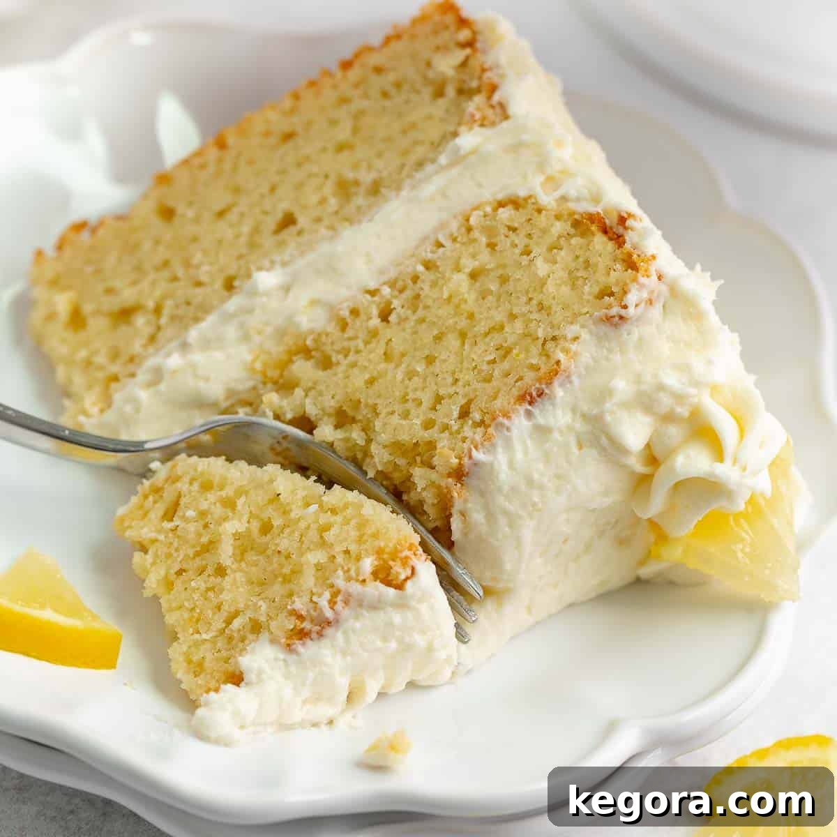A vibrant slice of gluten-free lemon cake with a light cream cheese frosting on a plate, radiating sunshine.