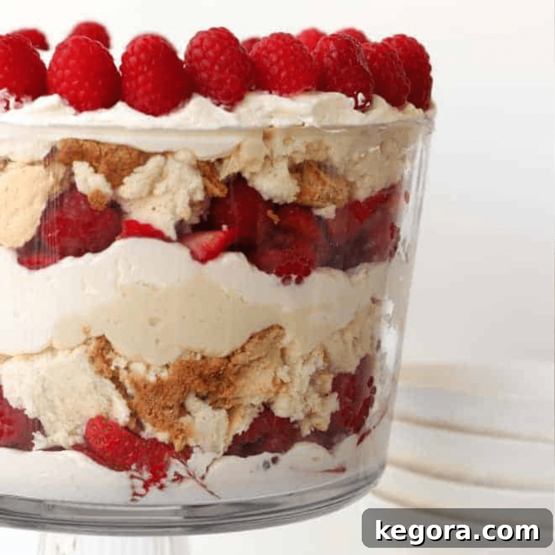 A beautiful gluten-free trifle layered with fresh berries, cake, and cream, displayed in a elegant trifle dish.