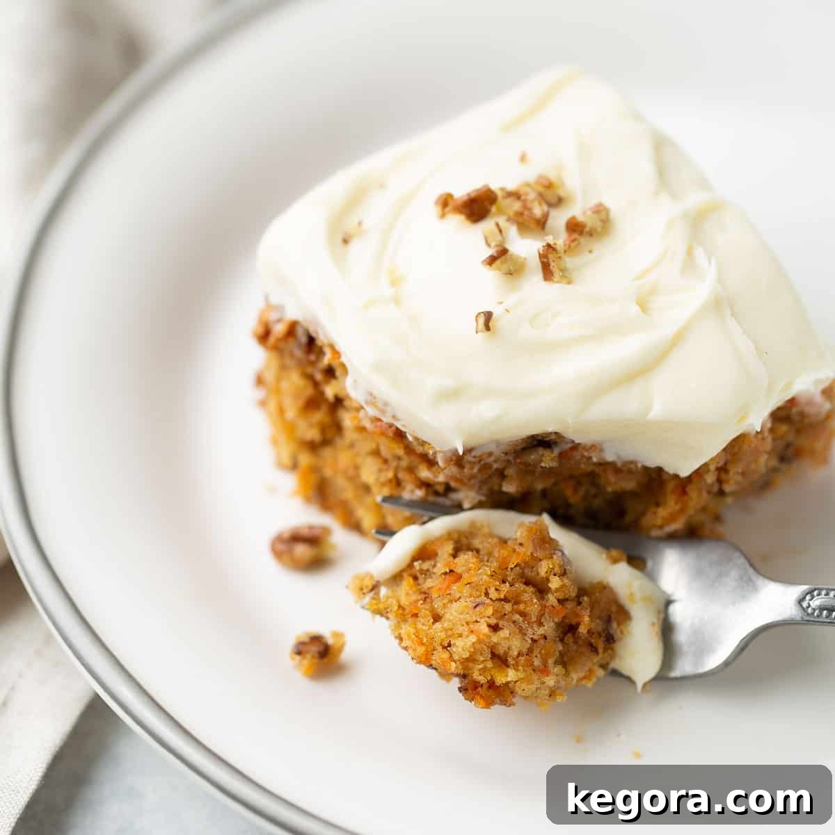 A perfectly moist slice of gluten-free carrot cake with luscious cream cheese frosting.