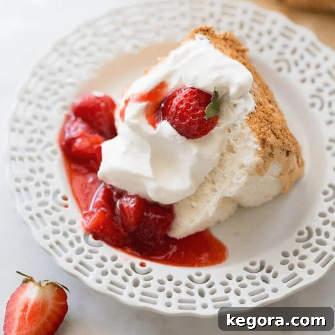 A light and airy slice of perfect gluten-free angel food cake, ready to be enjoyed.