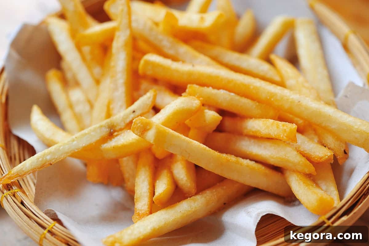 The Gluten-Free Truth About French Fries 3 close up basket of french fries on white parchment paper