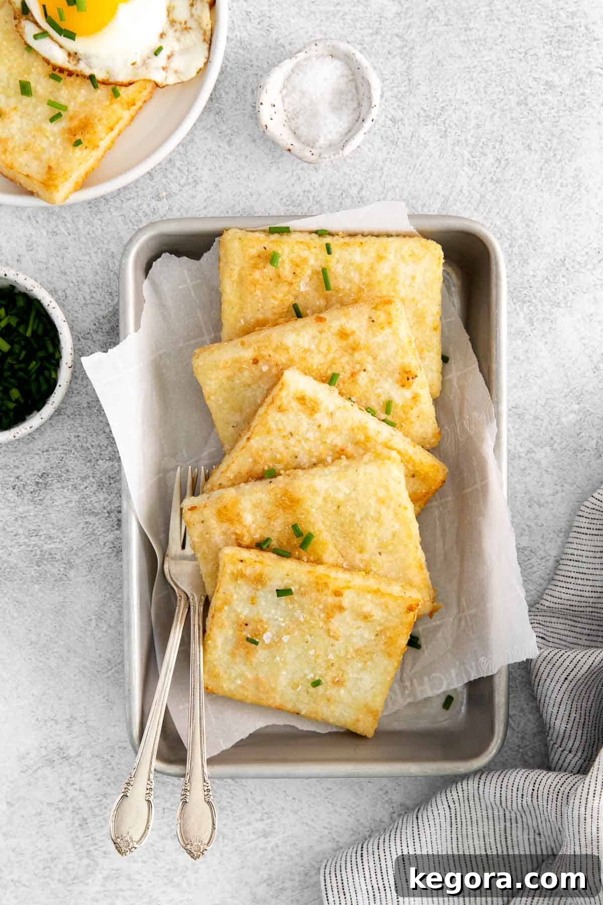Golden Grit Fritters 3 Crispy grit cakes displayed on an elegant serving tray, garnished and ready to enjoy.