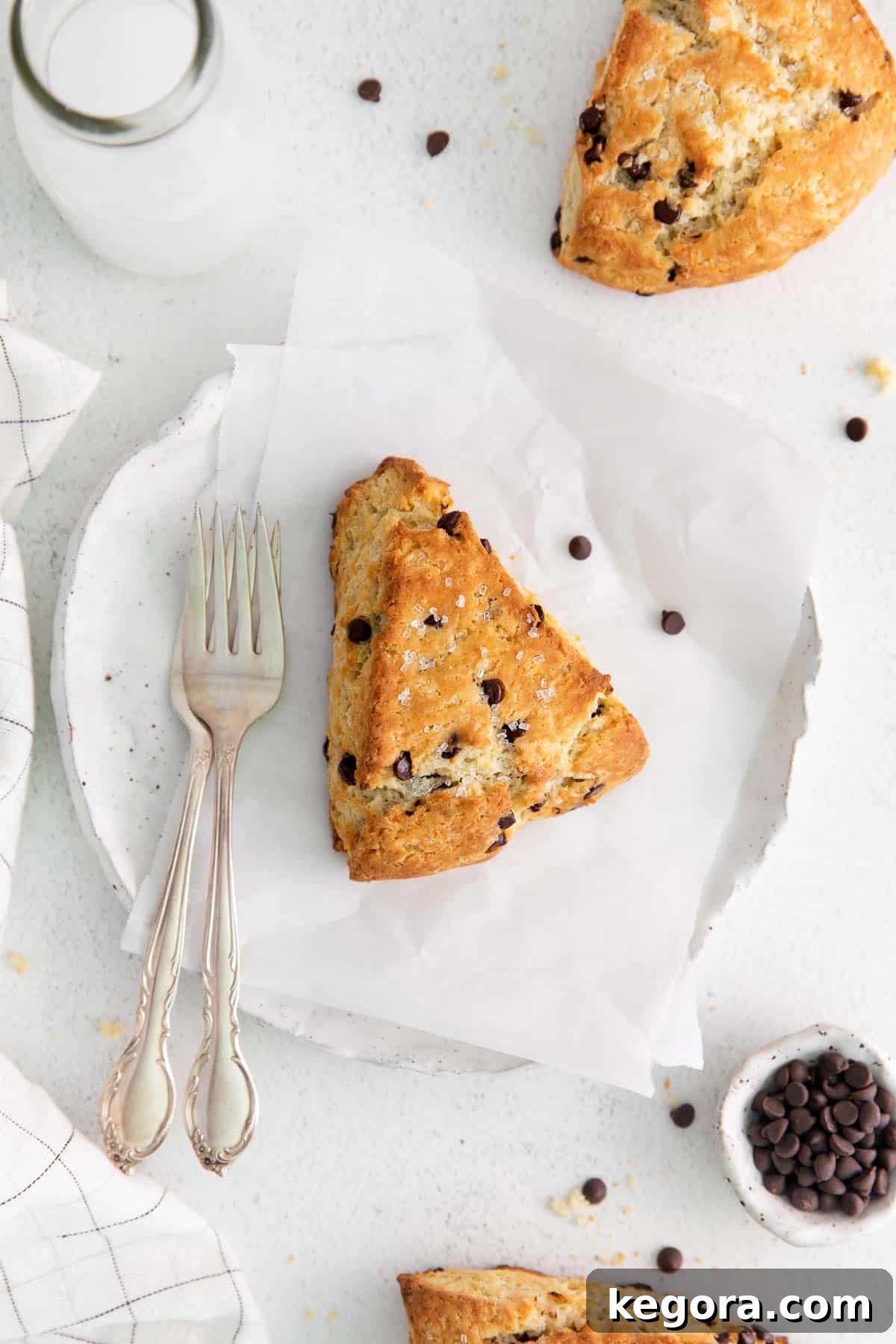 A single gluten-free chocolate chip scone resting on parchment paper
