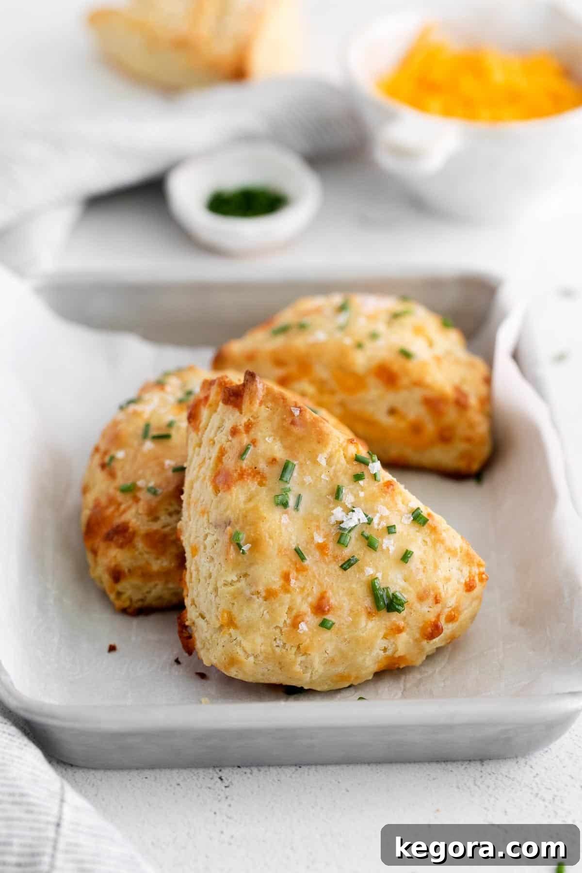 Fluffy Gluten-Free Cheese Scones 9 Warm gluten-free cheese scones arranged in a rustic dish, ready to be served, brushed with chive butter.