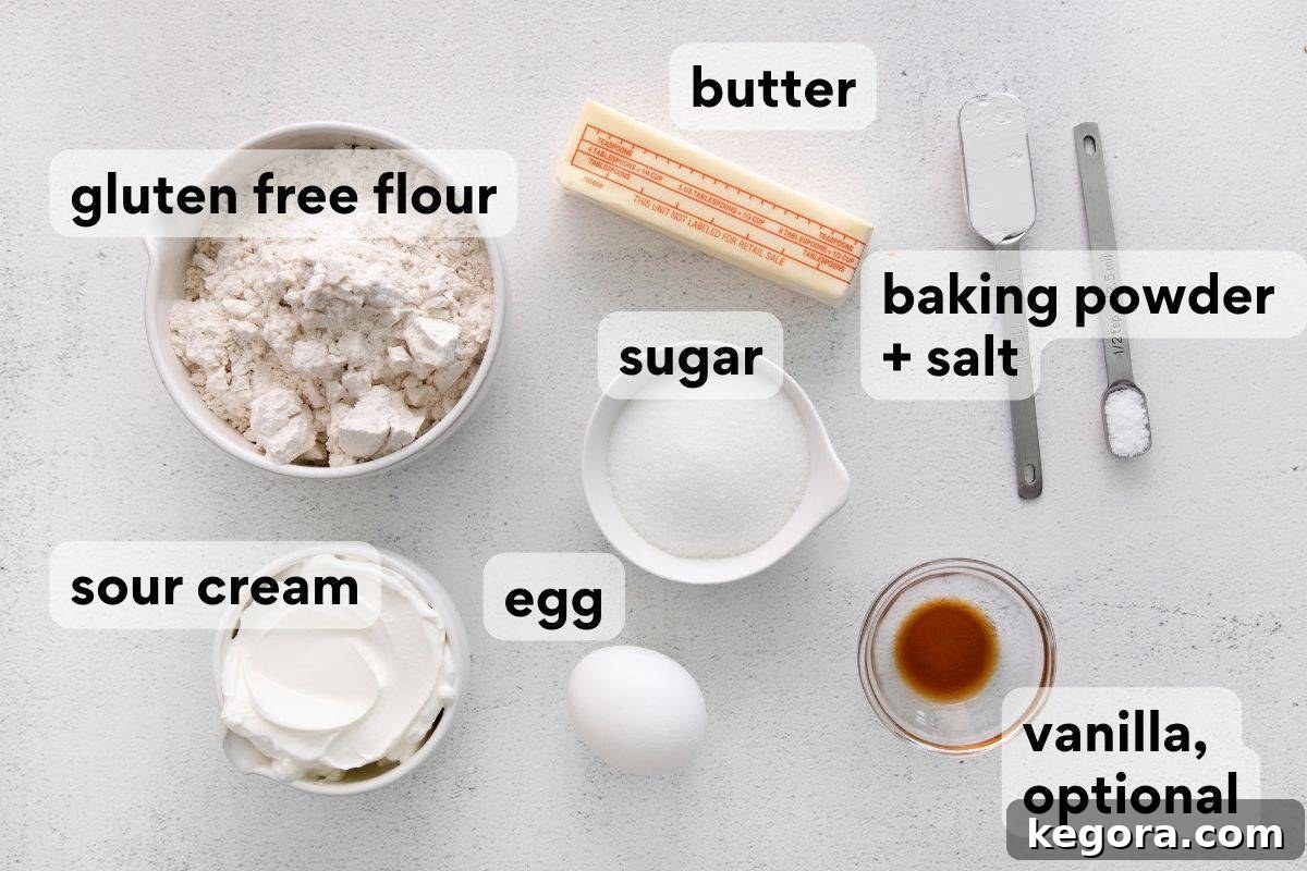 Fluffy Gluten-Free Scones Made Easy 4 Overhead shot of all the key ingredients laid out on a counter to make gluten-free scones: flour, butter, sour cream, egg, sugar, baking powder, salt.