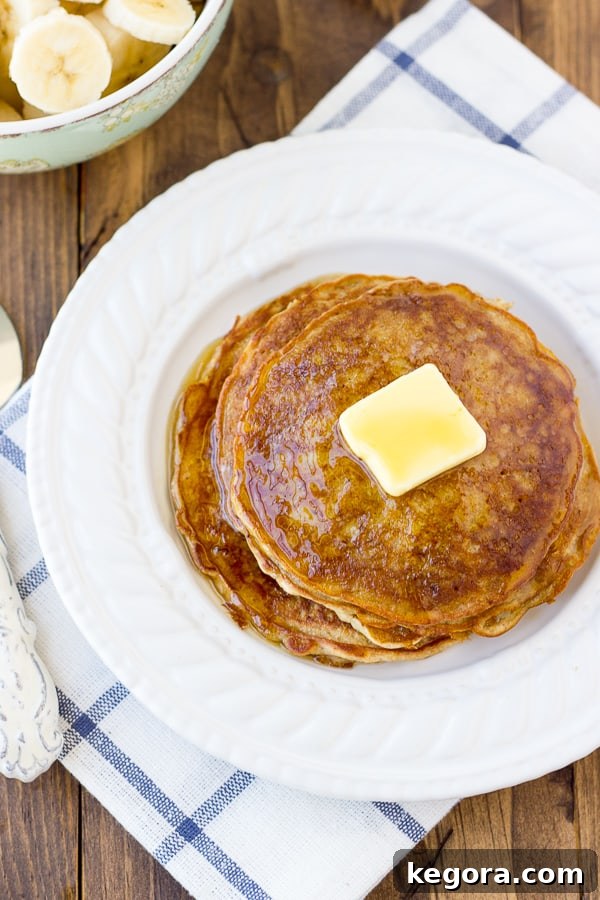 Morning-Ready Gluten-Free Dairy-Free Cinnamon Oatmeal Pancakes 2 Fluffy Gluten-Free Oatmeal Cinnamon Pancakes Stacked High with Berries