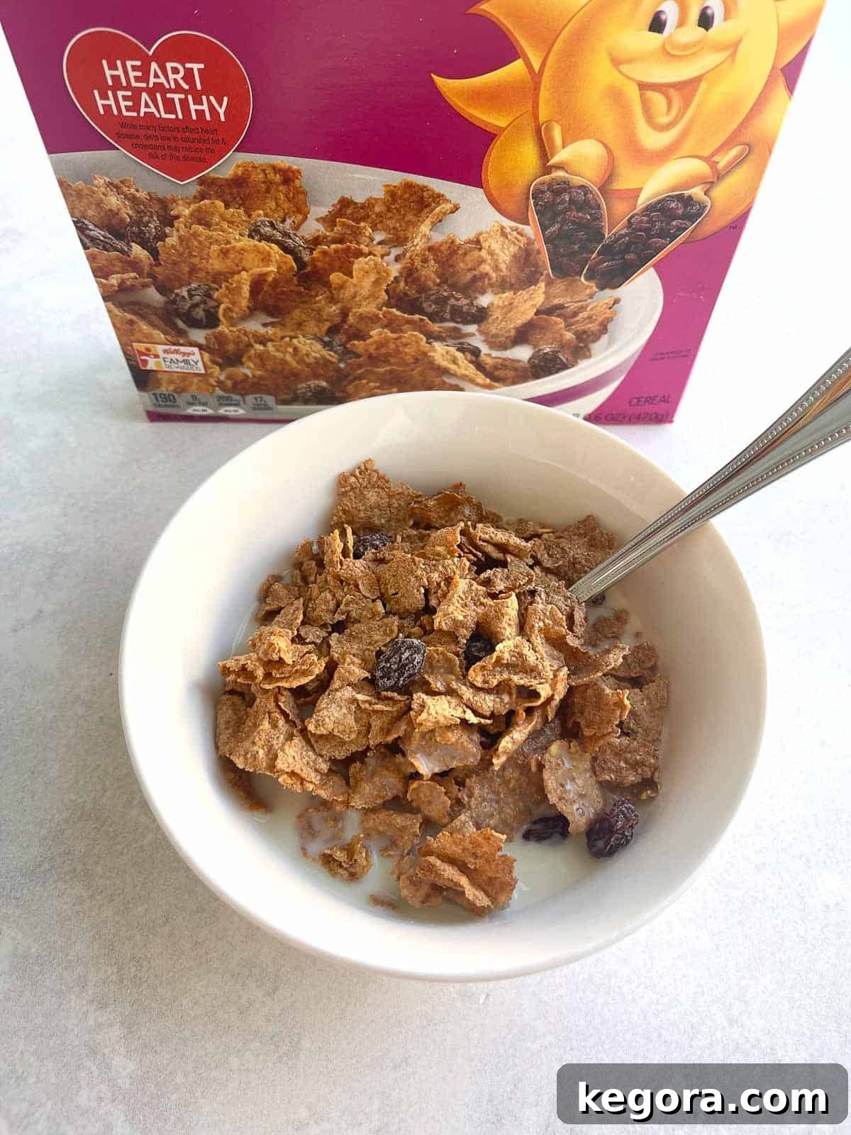 Raisin Bran cereal poured in a bowl, with a spoon