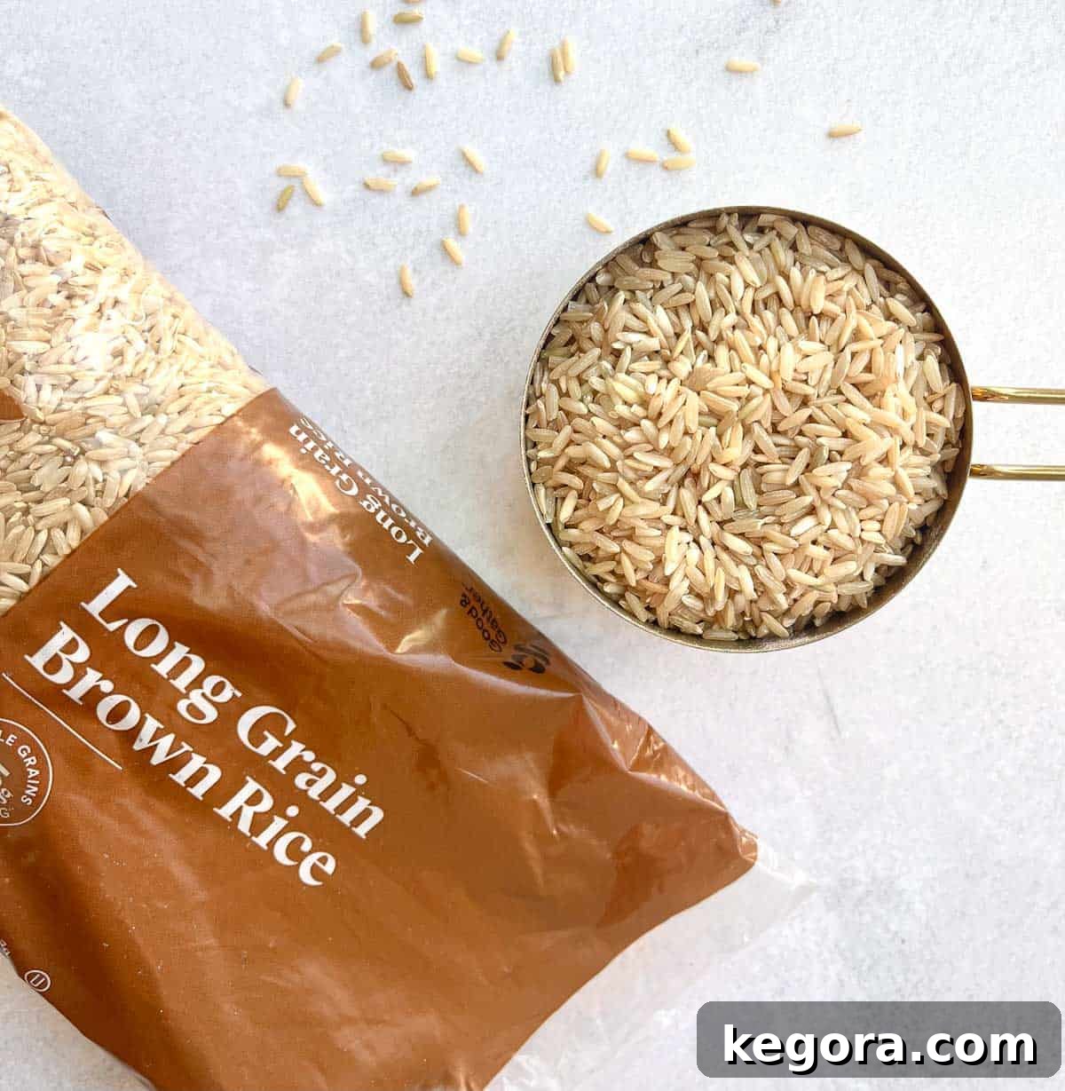 A bag of brown rice on the counter, next to a measure cup filled with brown rice