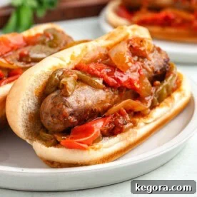 Sausage and peppers served in a bun, ready to eat.