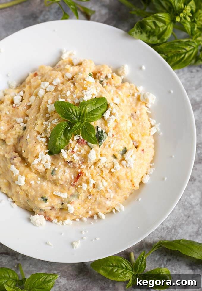 No-Stir Instant Pot Polenta 5 Polenta on a white plate garnished with basil