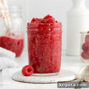 Freshly made raspberry compote in a mason jar, ready to be served or stored.
