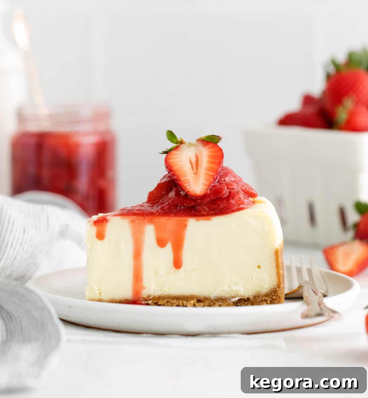 Luscious Strawberry Compote 7 A delectable slice of creamy cheesecake generously topped with vibrant strawberry compote, showcasing a perfect dessert pairing