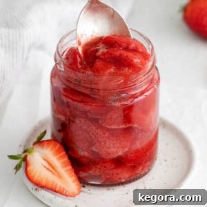 Luscious Strawberry Compote 8 A closeup of strawberry compote in a glass jar, highlighting its rich color and texture
