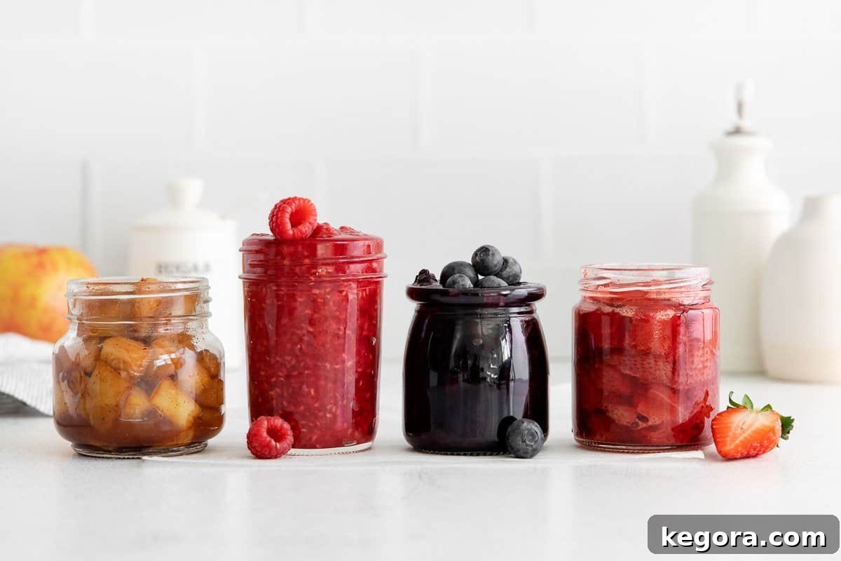 Crafting Delicious Fruit Compote from Scratch 3 Apple, raspberry, blueberry, and strawberry fruit compote arranged in glass jars on a countertop