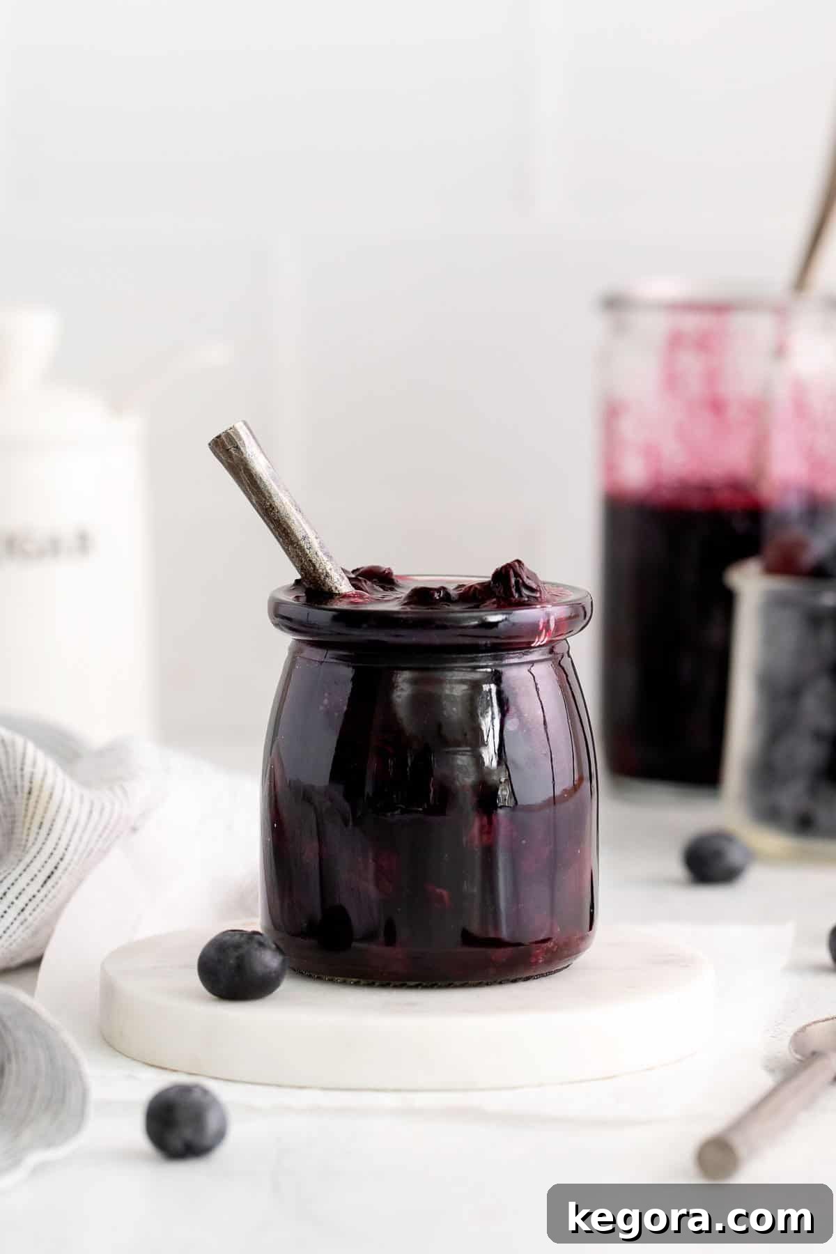 Crafting Delicious Fruit Compote from Scratch 6 Blueberry compote in a jar, surrounded by cooking supplies