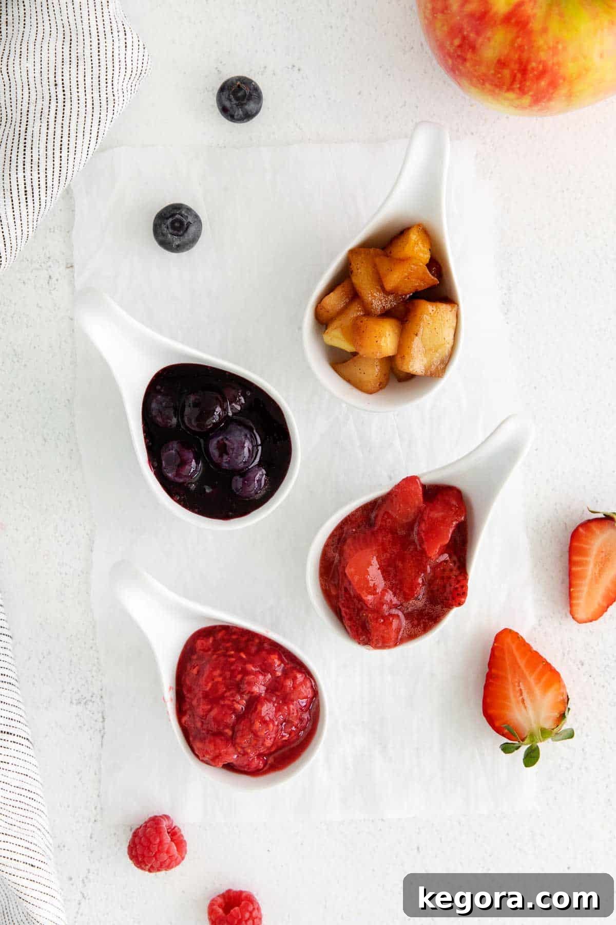 Crafting Delicious Fruit Compote from Scratch 9 A variety of fruit compotes placed in ladles on a countertop, surrounded by fruit