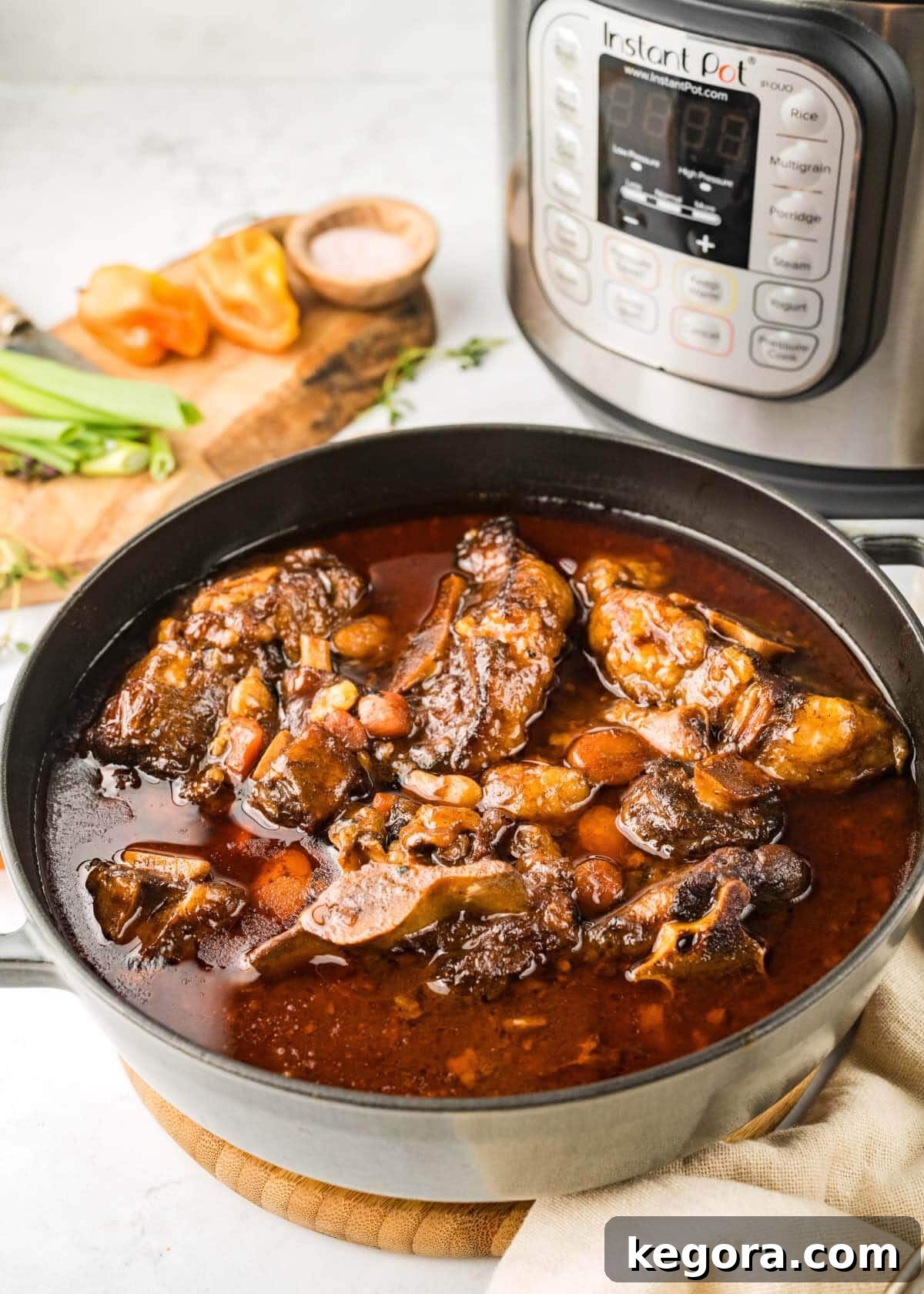 Instant Pot Oxtail Stew in a pot with IP next to it