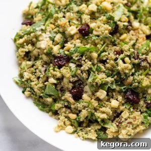 A close-up shot of a healthy and colorful quinoa salad in a pristine white serving dish.