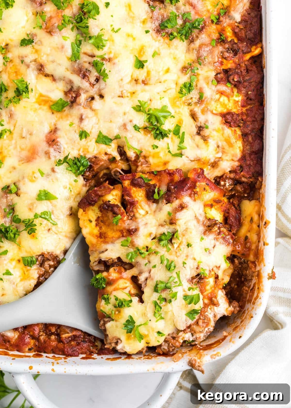 Sliced Ravioli Lasagna in a white baking dish, ready to serve.
