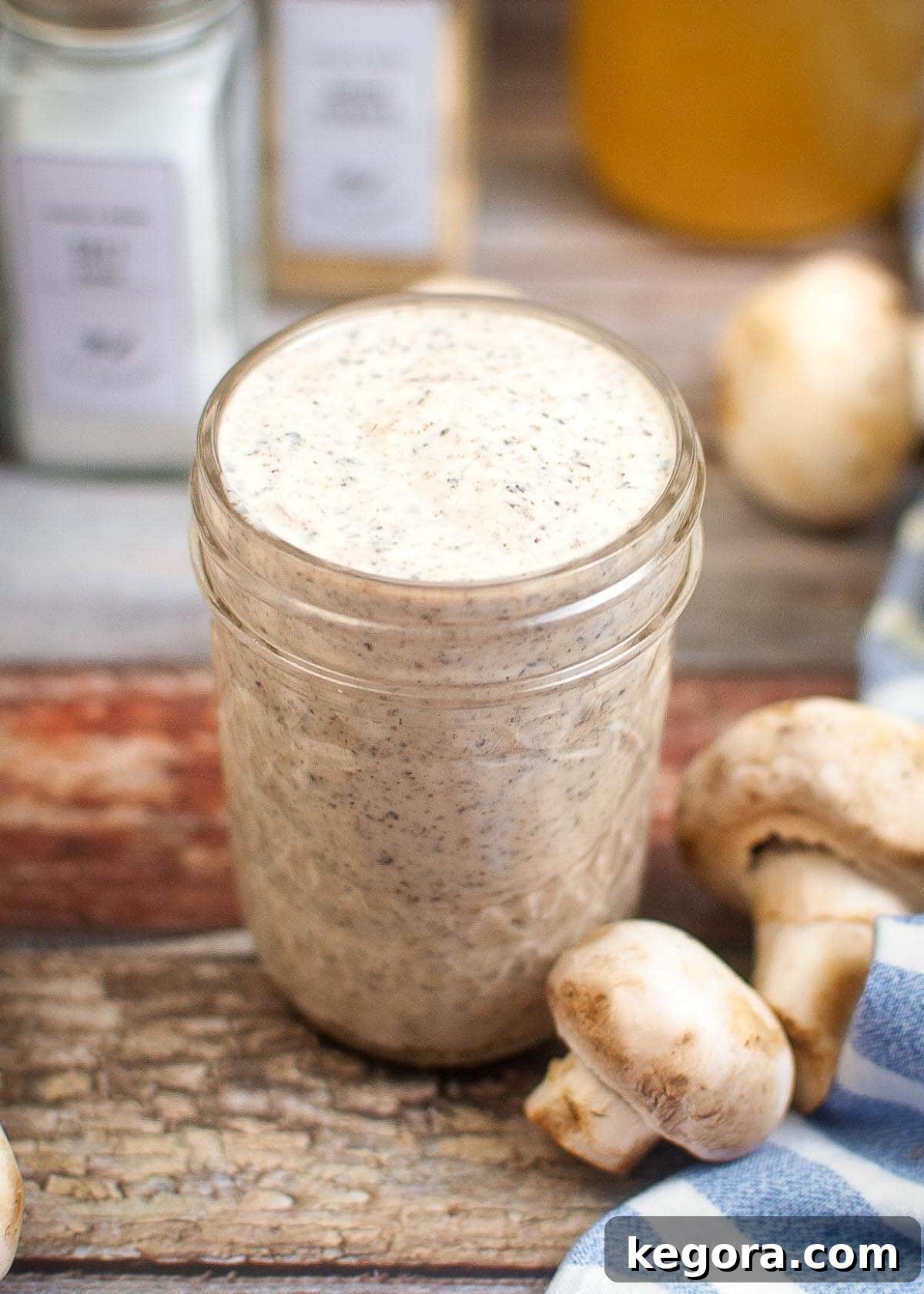Thick and Creamy Homemade Mushroom Soup 2 A glass jar filled with rich, creamy homemade condensed cream of mushroom soup, ready for storage or use.