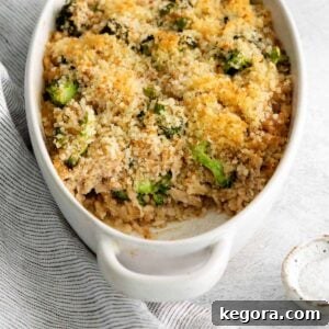 Chicken rice casserole in a dish on the table, surrounded by ingredients.