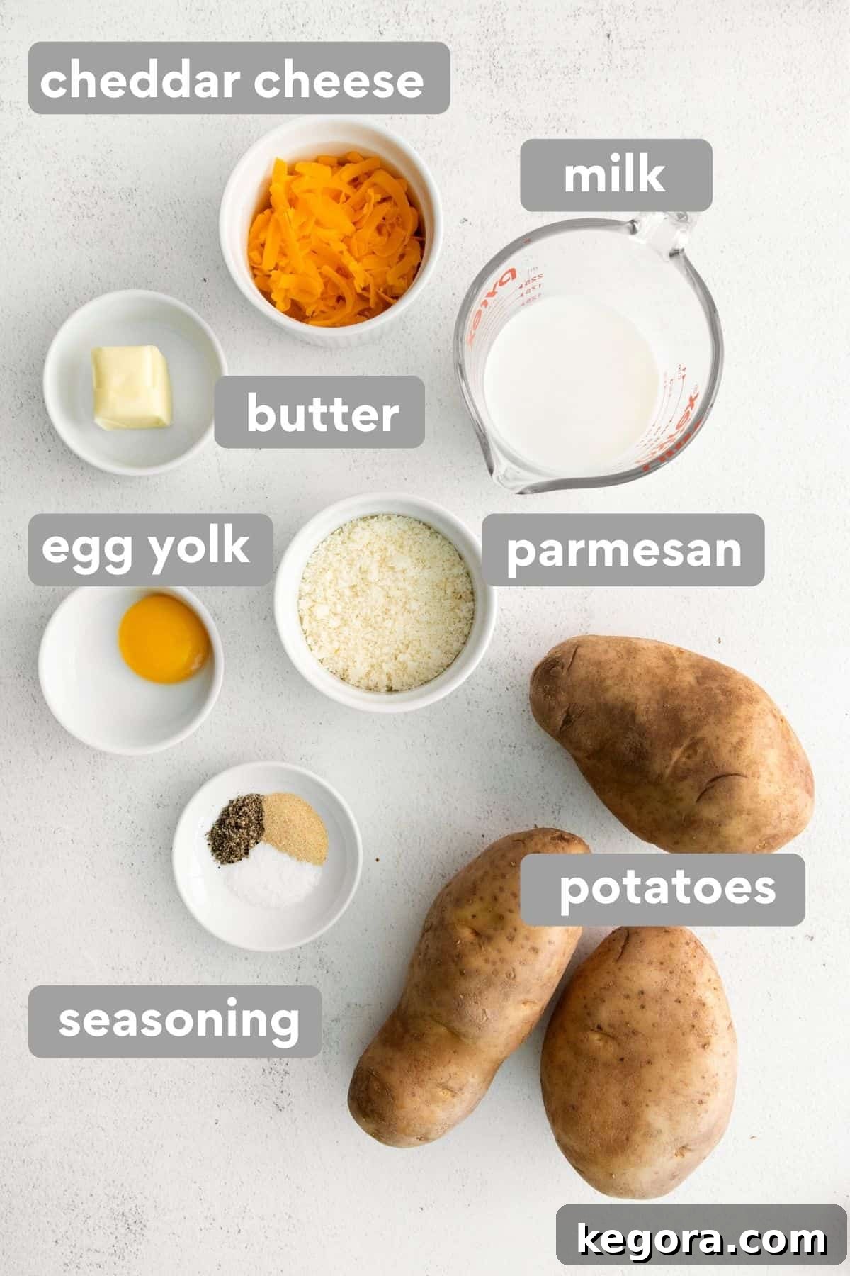 Hearty Gluten-Free Shepherds Pie 5 Ingredients for the mashed potato topping, including russet potatoes, butter, milk, and shredded cheese, arranged on a kitchen counter.