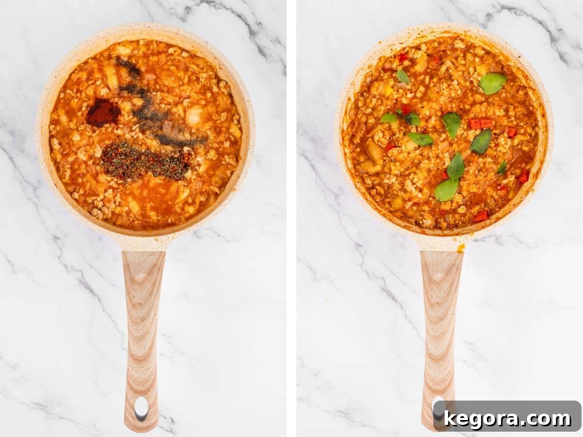 Image showing spices, bell peppers, and fresh basil being stirred into the chicken and tomato filling in a pan.