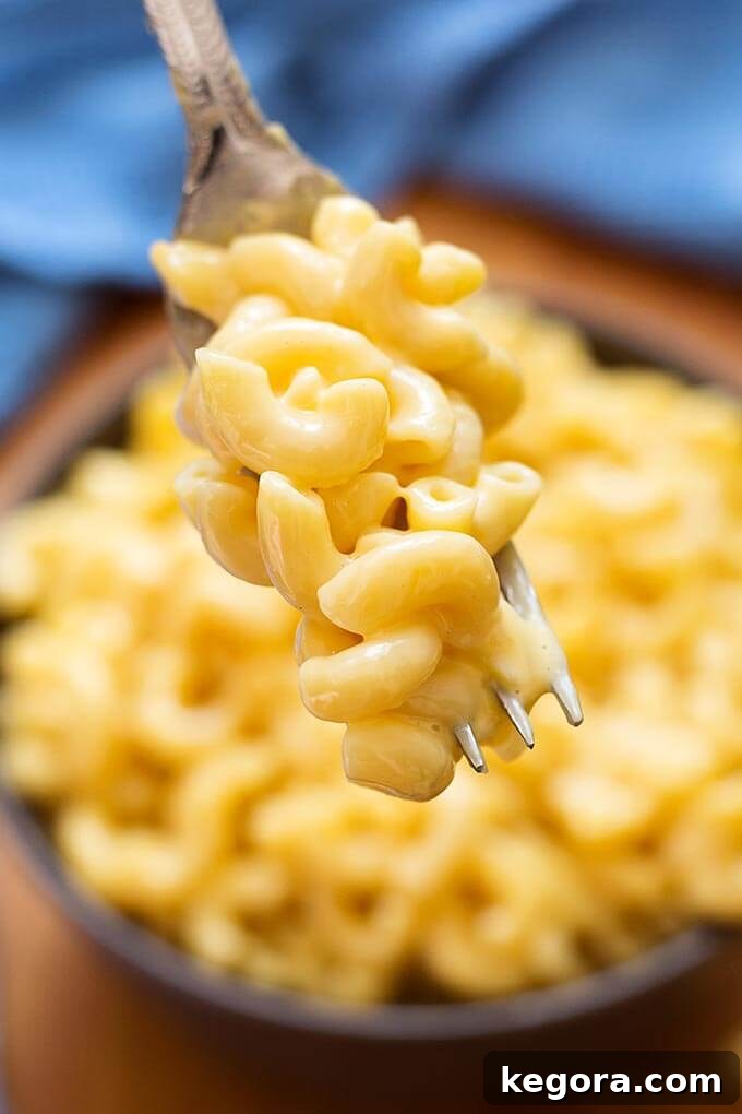 Instant Pot Mac and Cheese on a fork, showing creamy texture.