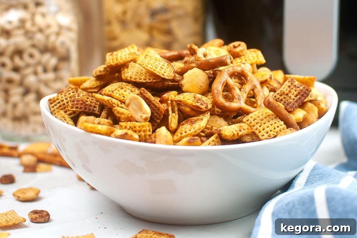 Quick and Crispy Air Fryer Chex Mix 8 Air Fryer Chex Mix in a white bowl