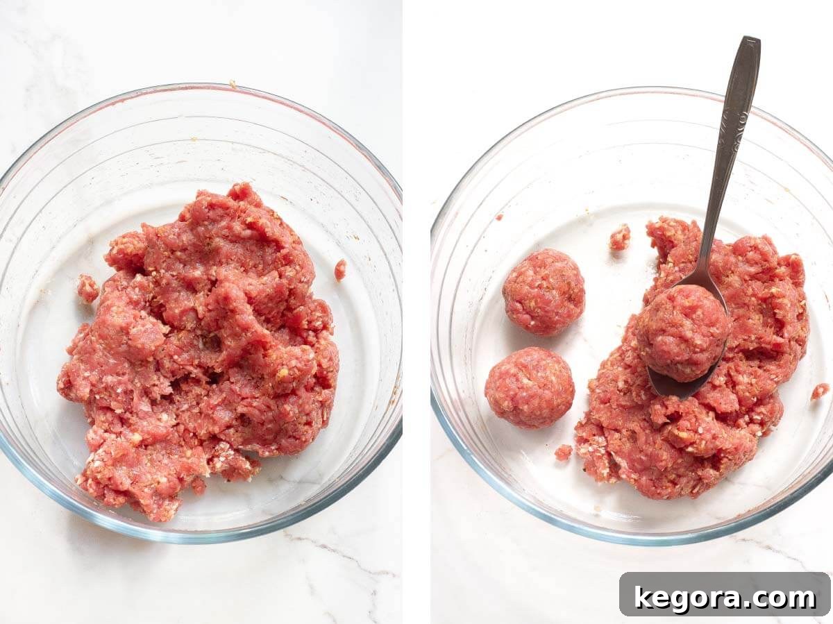 Classic Salisbury Steak Bites 5 Ground beef in a clear mixing bowl, with hands beginning to form meatballs.