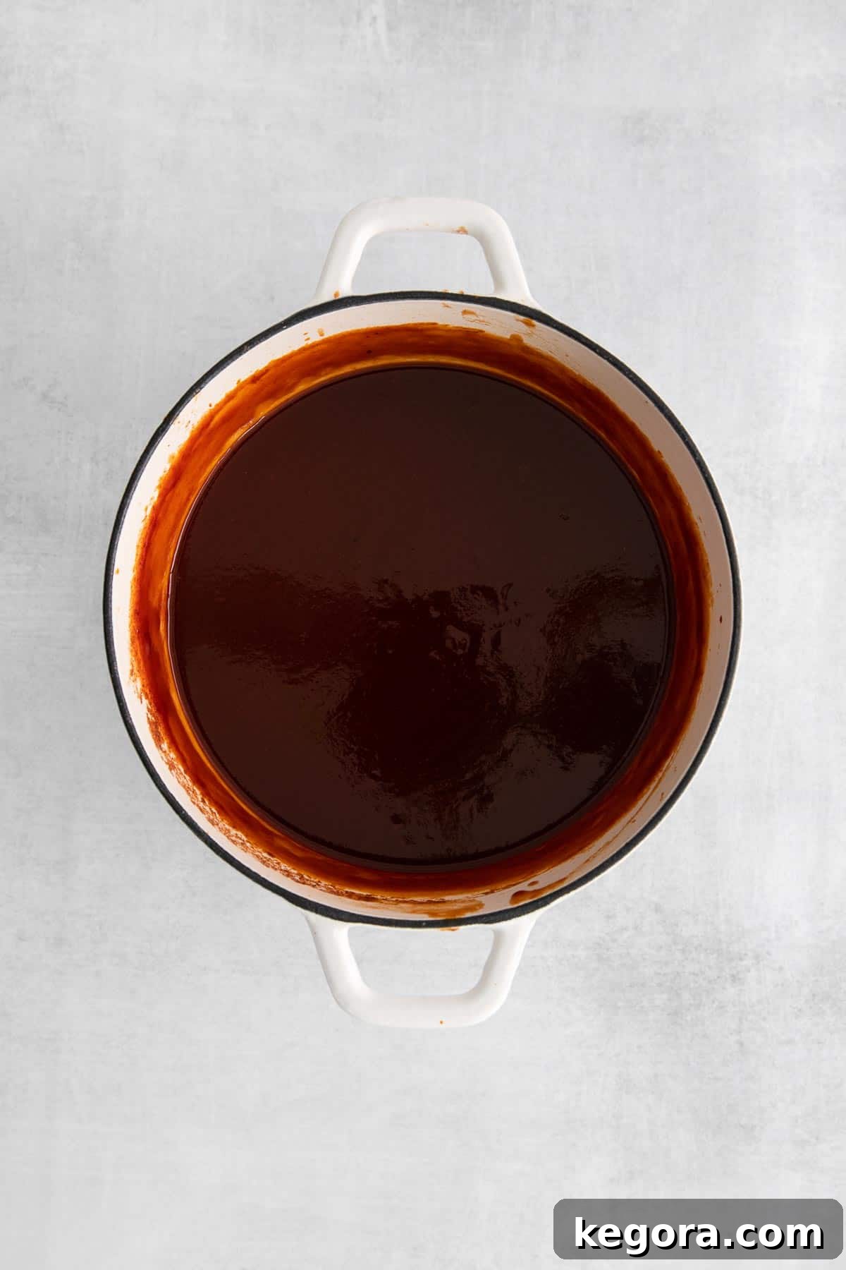 Gluten-free BBQ sauce in a saucepan, mixed