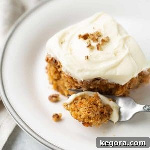 carrot cake on white plate with fork
