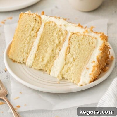 A slice of coconut cake on a plate