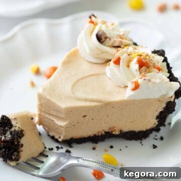 slice of peanut butter pie with gluten free oreo crust on a white plate
