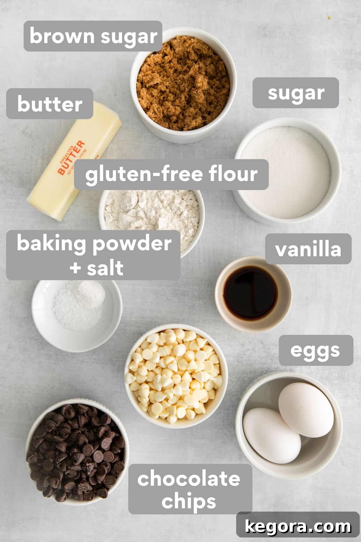 Various ingredients for gluten-free blondies, including flour, sugars, butter, eggs, vanilla, and chocolate chips, neatly displayed on a kitchen counter.