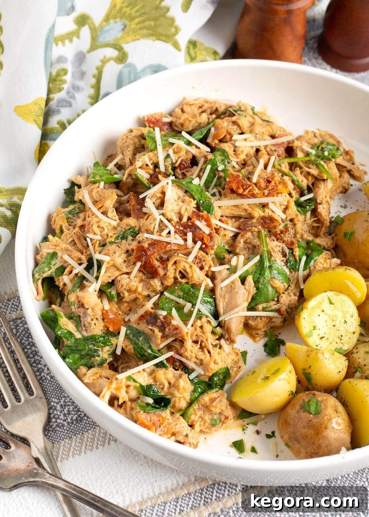 Effortless Slow Cooker Marry Me Chicken 2 A bowl of creamy Slow Cooker Marry Me Chicken, garnished with fresh basil.