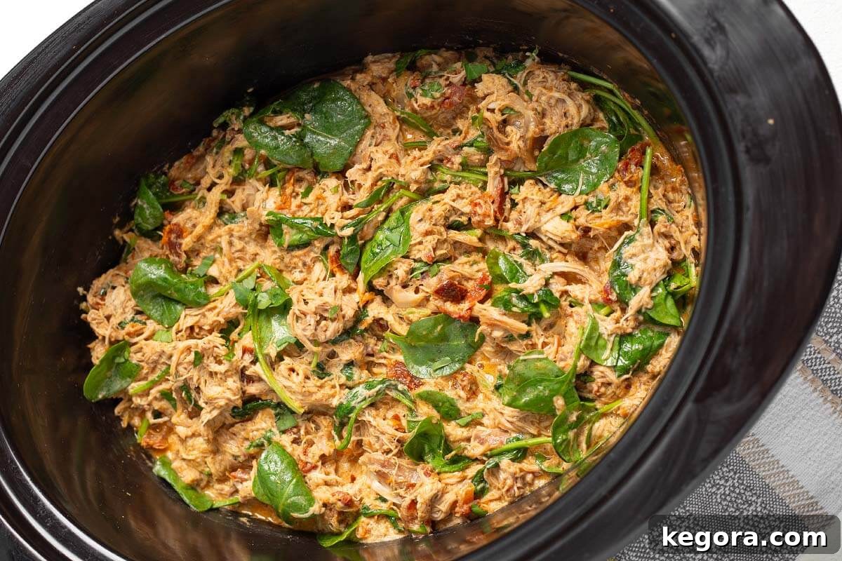 Effortless Slow Cooker Marry Me Chicken 9 Finished Slow Cooker Marry Me Chicken in a black crockpot, ready to serve.