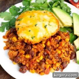 Slow Cooker Tamale Pie on a white plate with garnish.