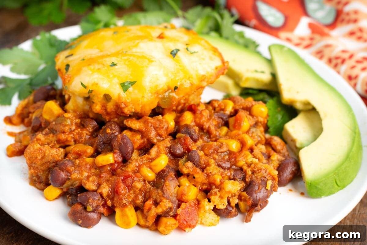 Slow Cooker Tamale Pie on a white plate with garnish.