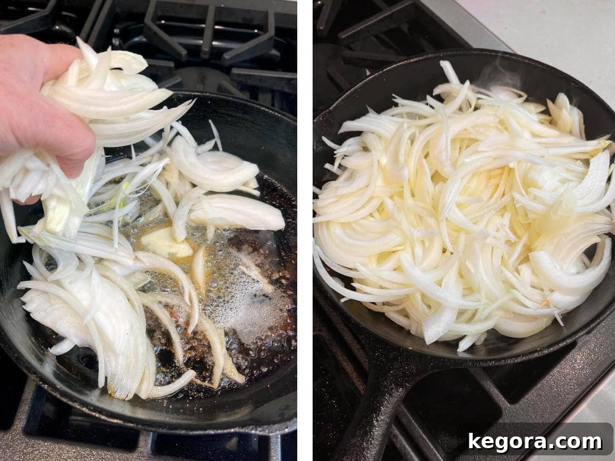 Sliced yellow onions frying in butter in a hot skillet, becoming tender and golden.
