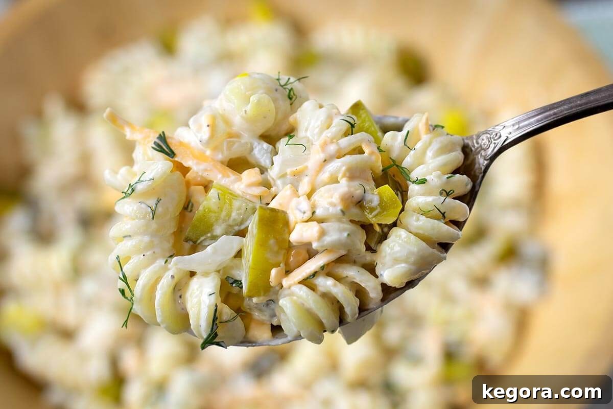 Zesty Dill Pickle Pasta Delight 3 Dill Pickle Pasta Salad on a spoon.
