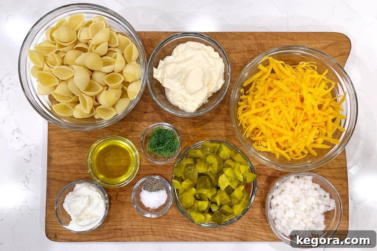 Zesty Dill Pickle Pasta Delight 5 Dill Pickle Pasta Salad ingredients shot on board.