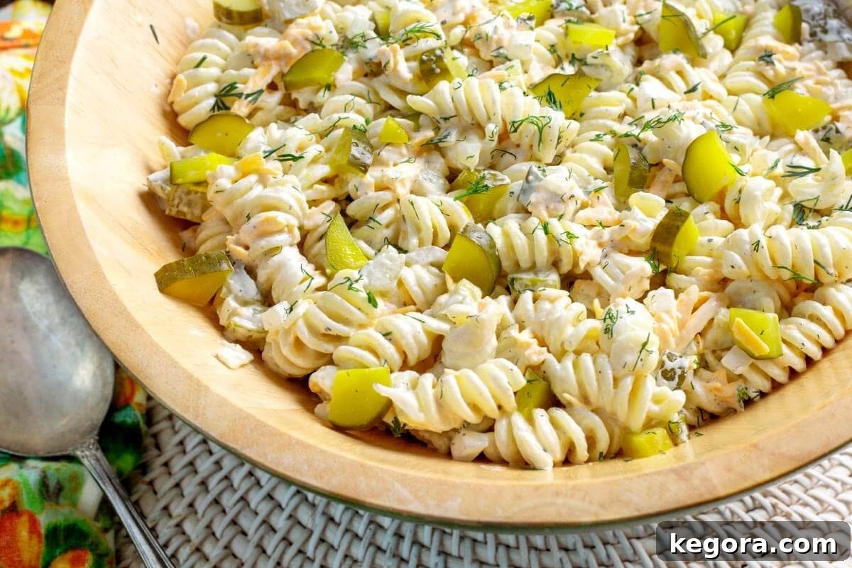 Zesty Dill Pickle Pasta Delight 10 Dill Pickle Pasta Salad in wood bowl.